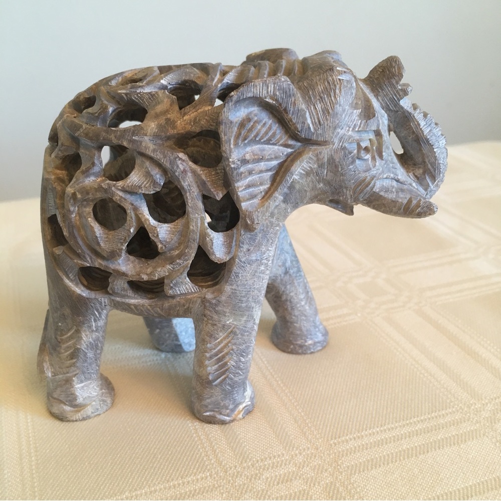 Intricately carved stone elephant with baby inside. 4 inches tall.